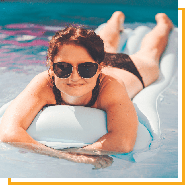 women on inflatable in the pool