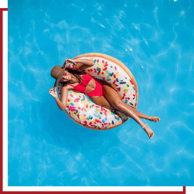 women in backyard pool on a floatie