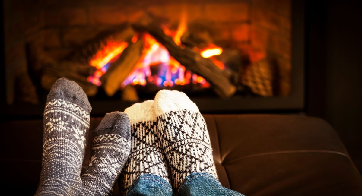 couple cozy on the couch with wood-burning fireplace