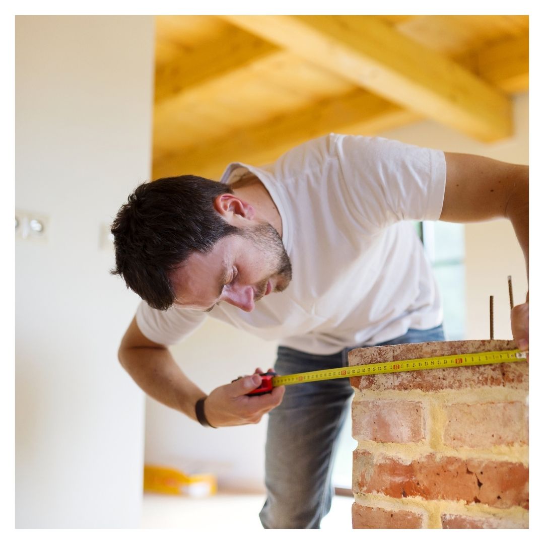 man measuring with tape measure