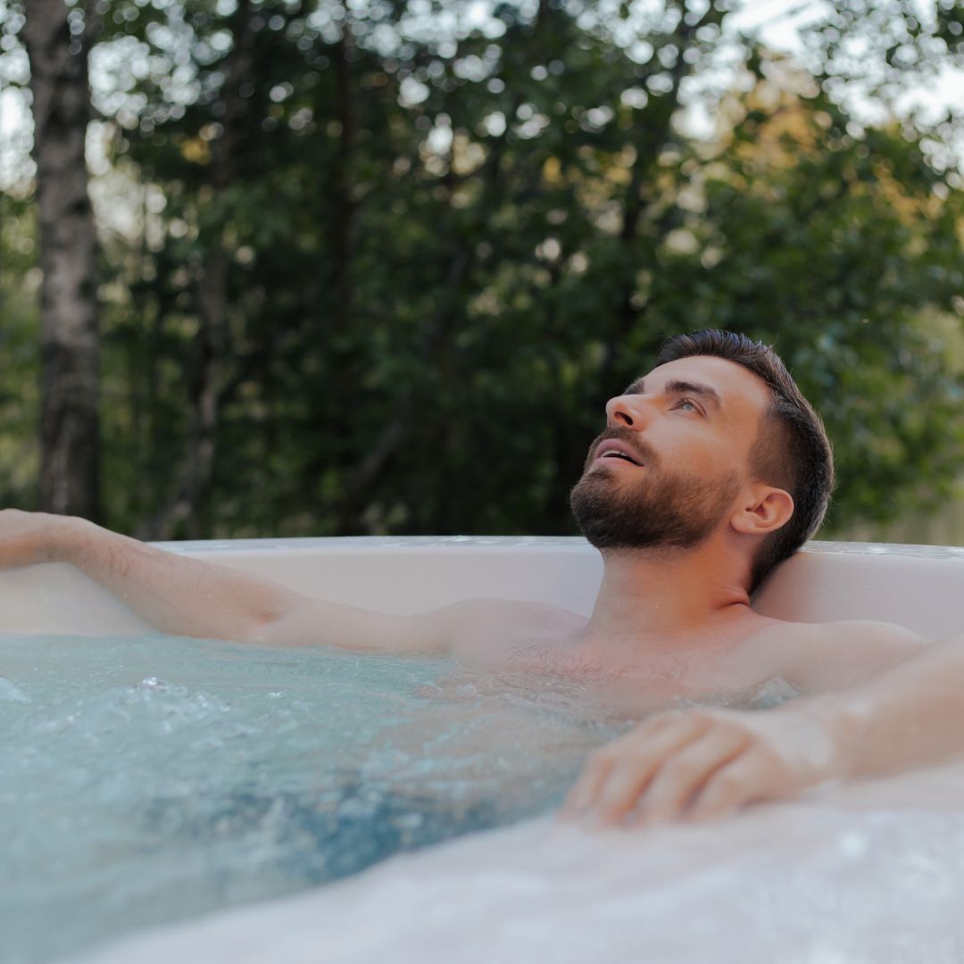 A man relaxing in a swim hot tub