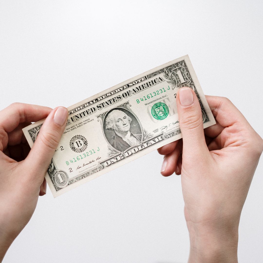 Someone holding a dollar