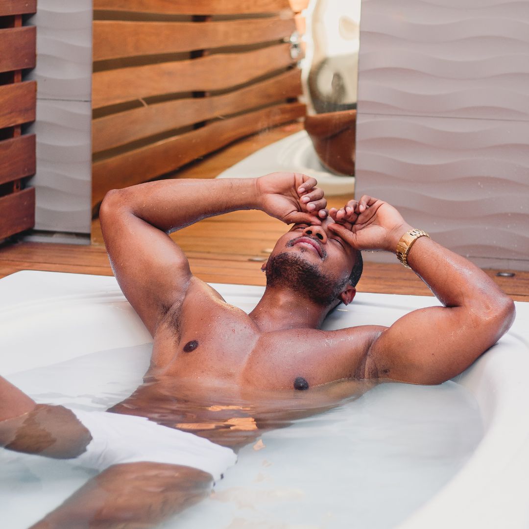 A man laying down in a tub