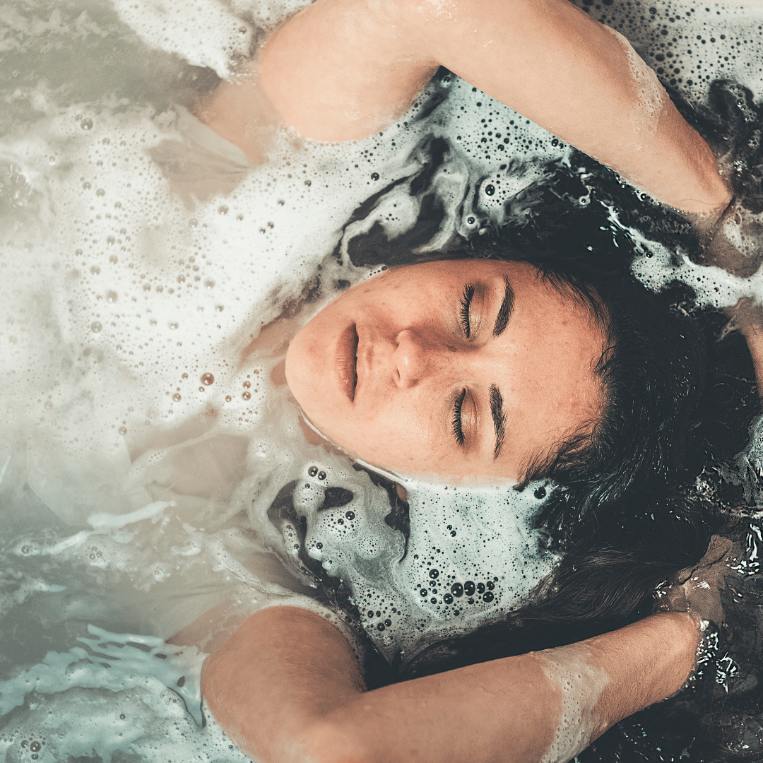 A women laying down in a hot tub