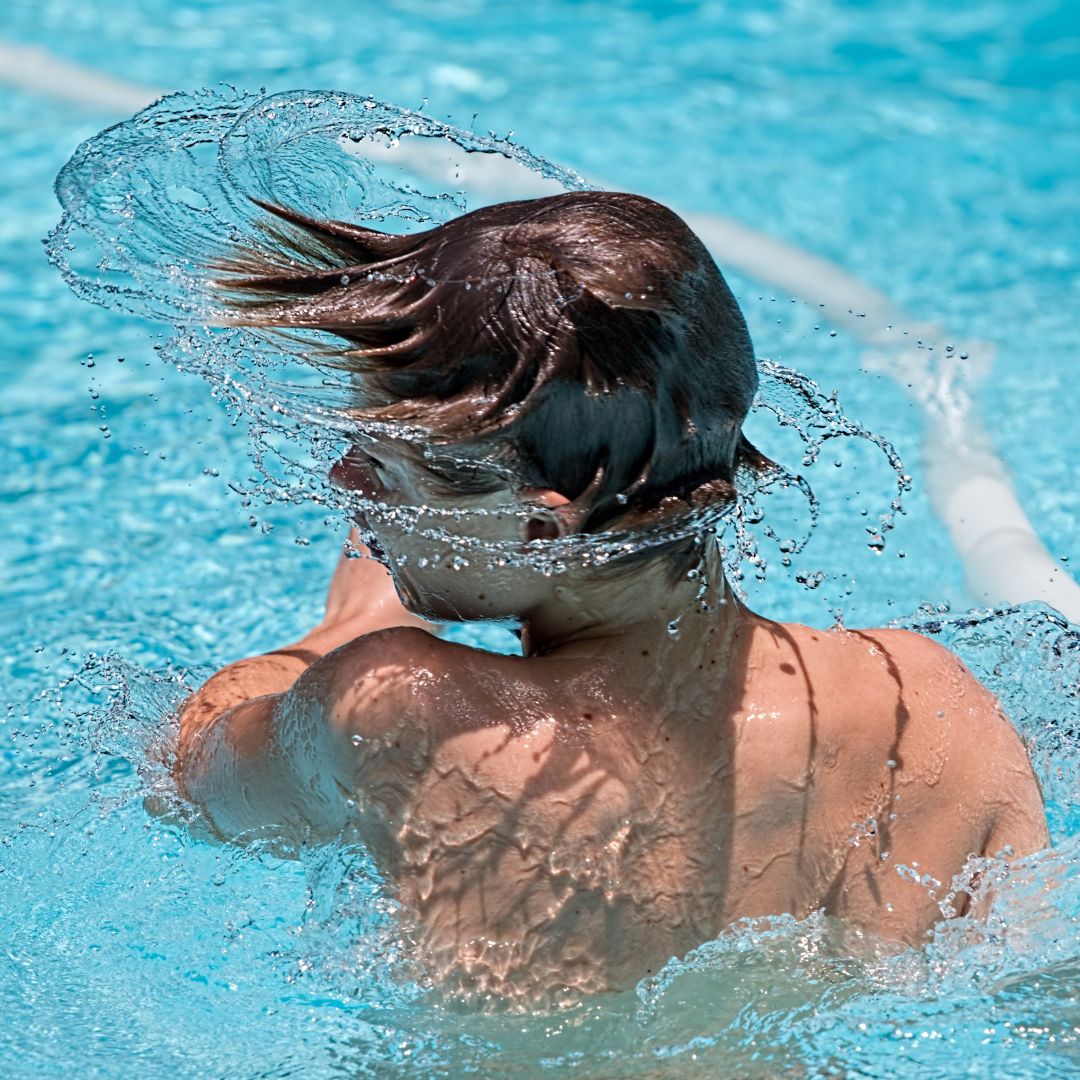 A boy shaking water out of his head