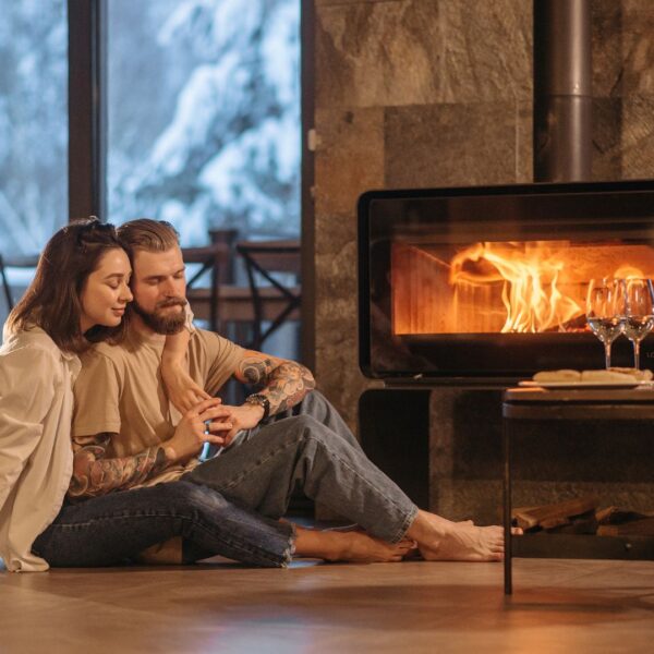 couple sitting by electric fireplace
