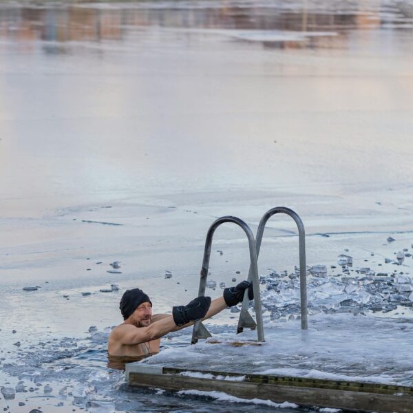 man cold plunging in lake