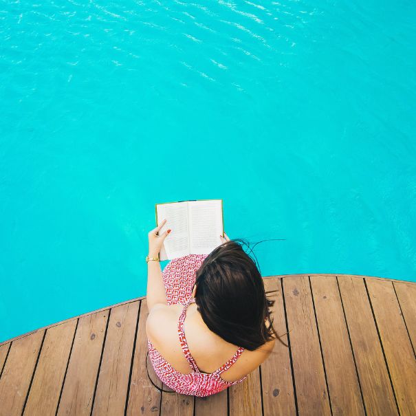 Woman sitting near pool