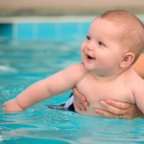 Baby smiling in pool water