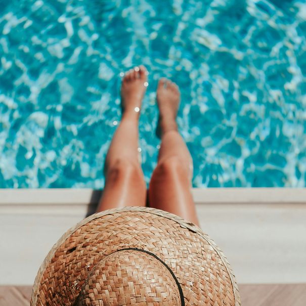 Woman sitting poolside