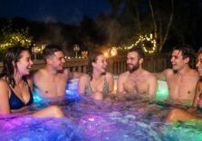 people in hot tub at night